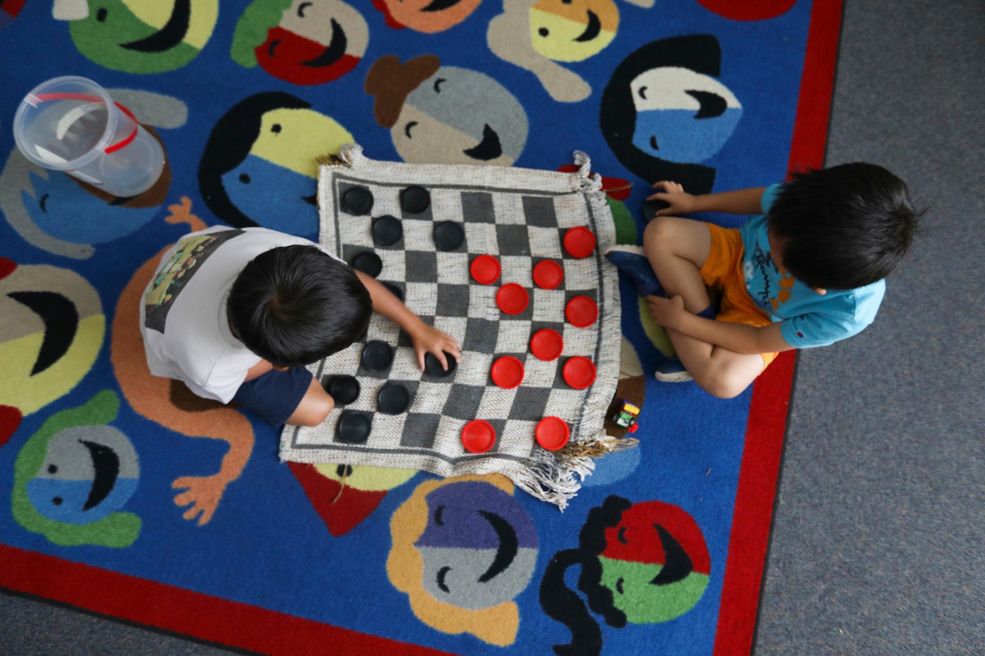 Two boys playing checkers 
