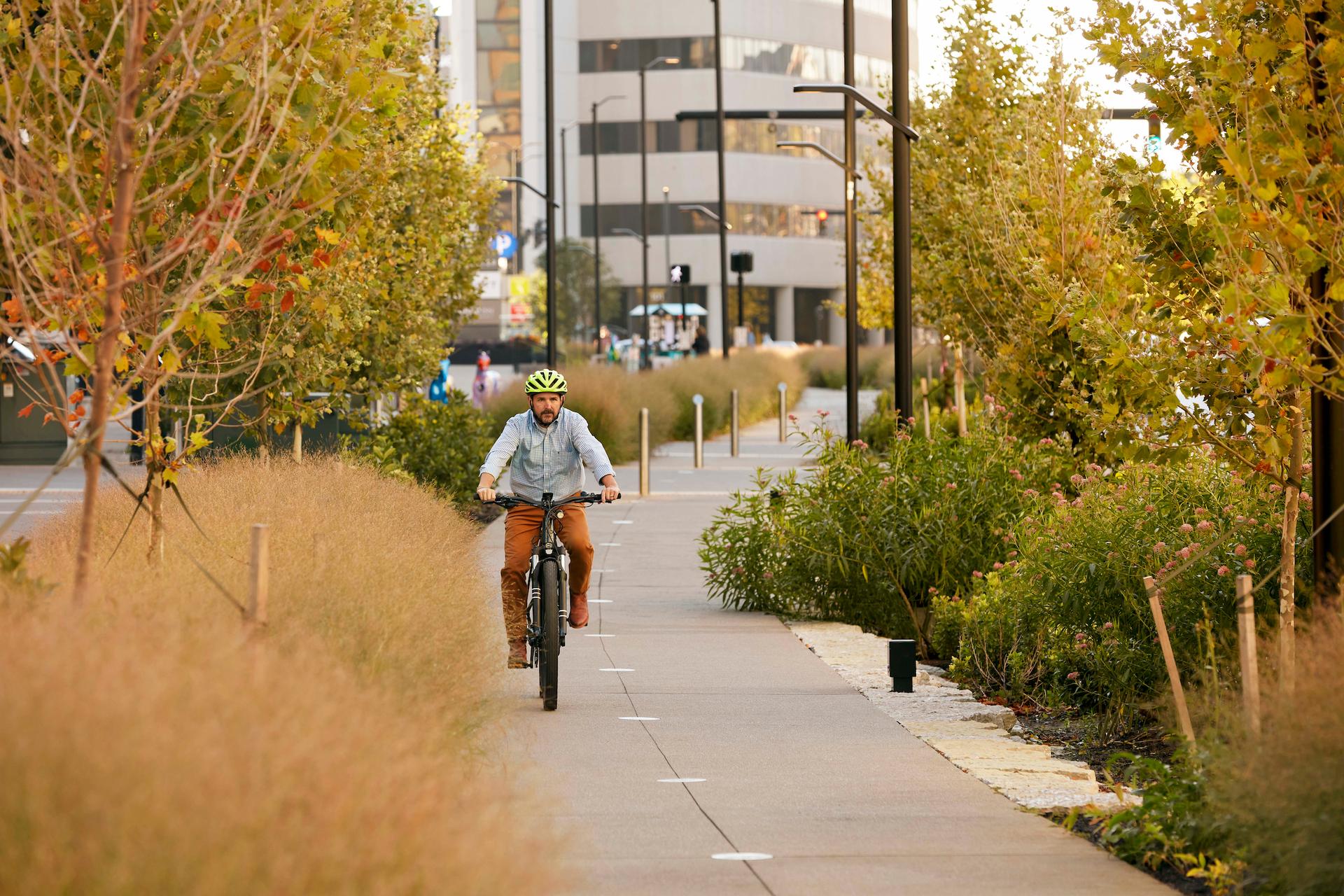 A cyclist riding town Town Branch Commons along Vine Street in Lexington. 