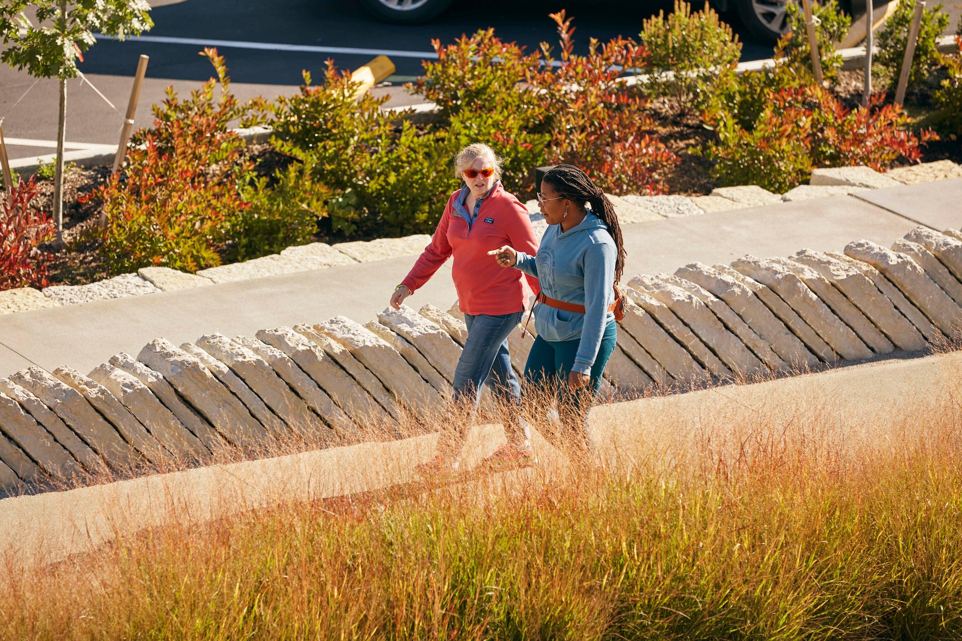 Two women walking along Town Branch Commons. 