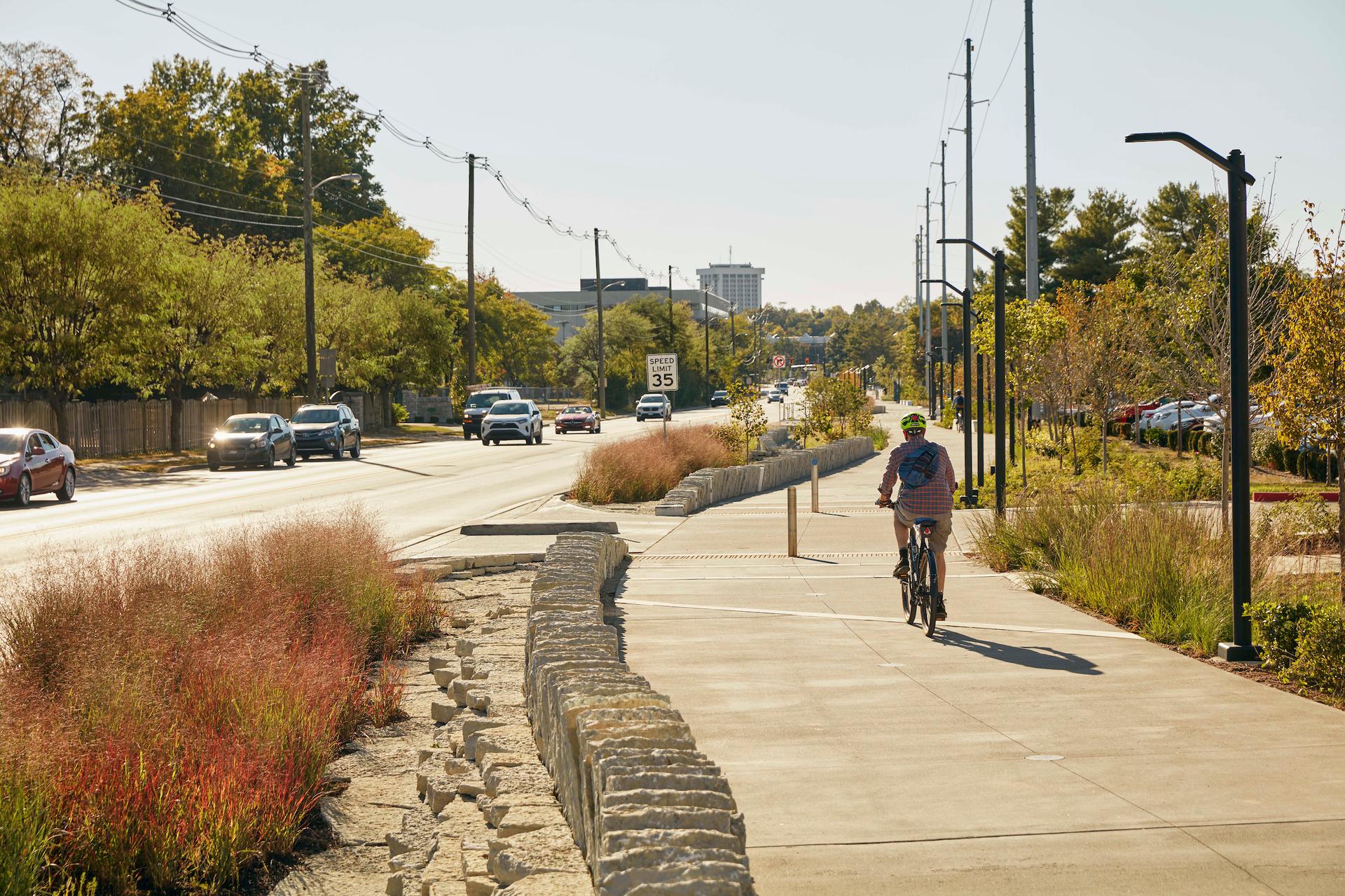 A cyclist riding town Town Branch Commons along Midland in Lexington. 