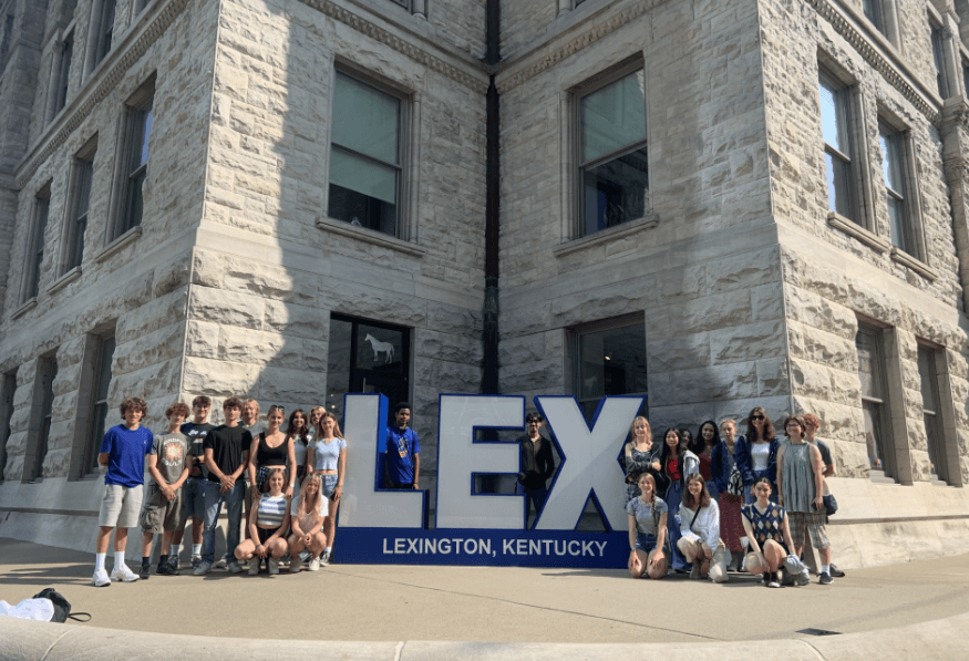 Teens in front of the LEX sign at the old courthouse.